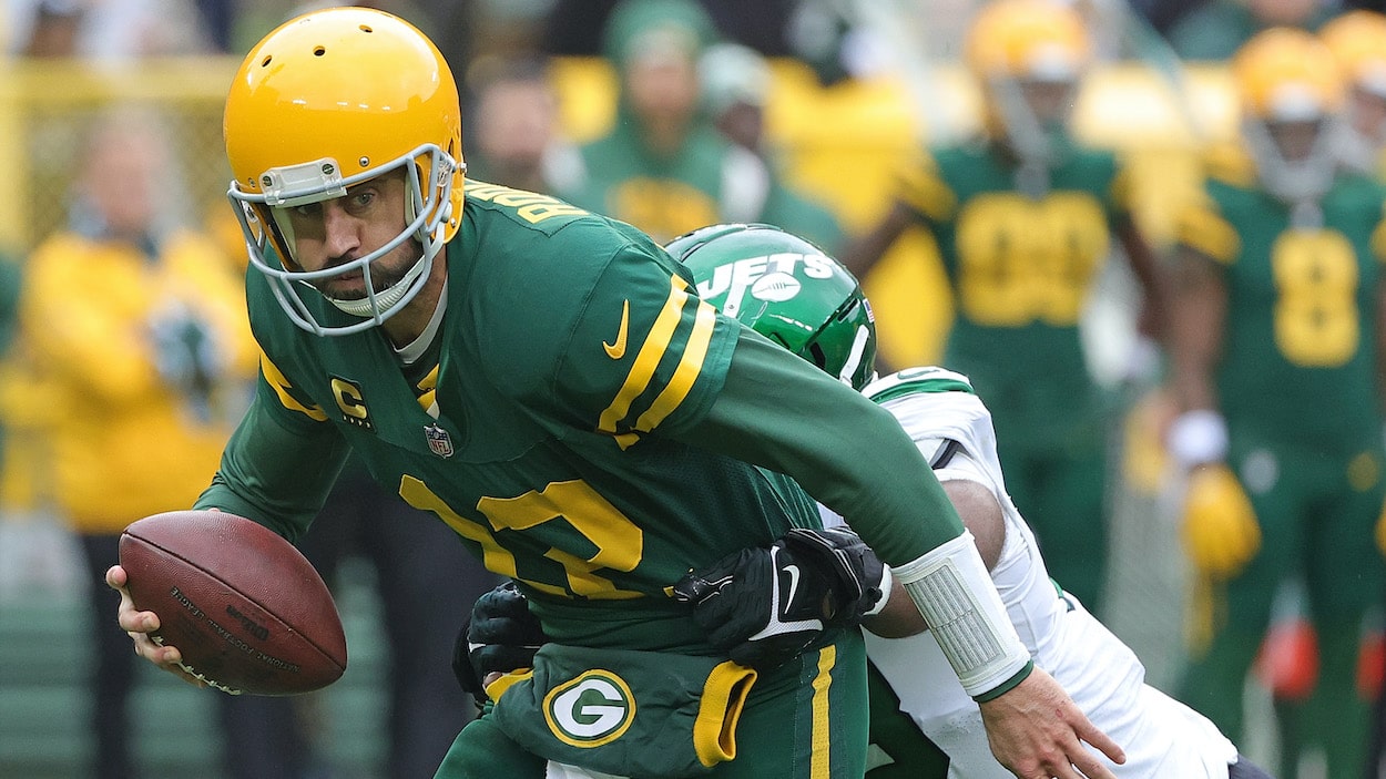 Aaron Rodgers of the Green Bay Packers is pursued by Sheldon Rankins of the New York Jets.