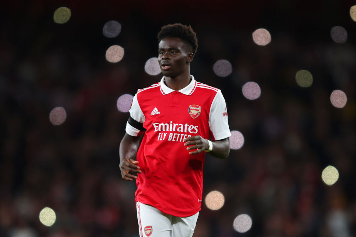 Bukayo Saka wearing an Adidas branded Arsenal kit.