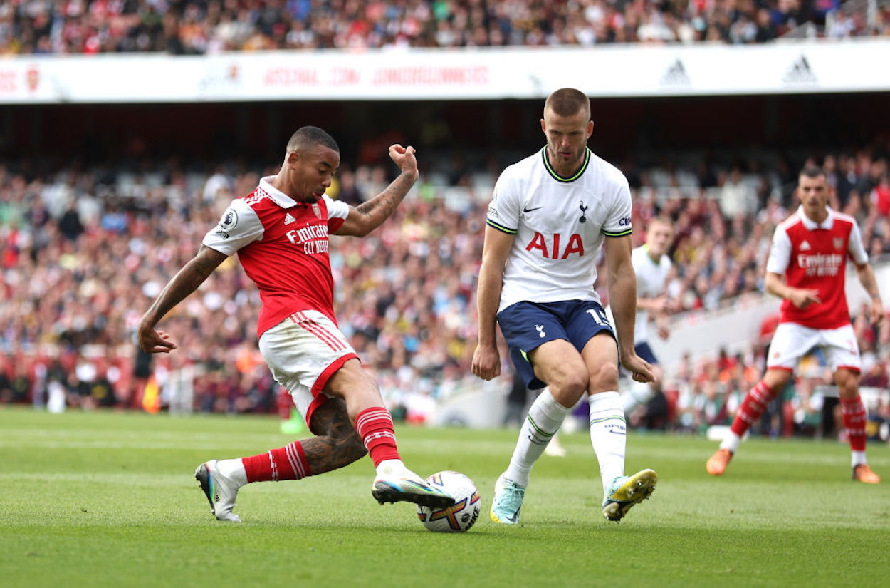 Arsenal forward Gabriel Jesus (L) dribbles toward Tottenham defender Eric Dier (R).