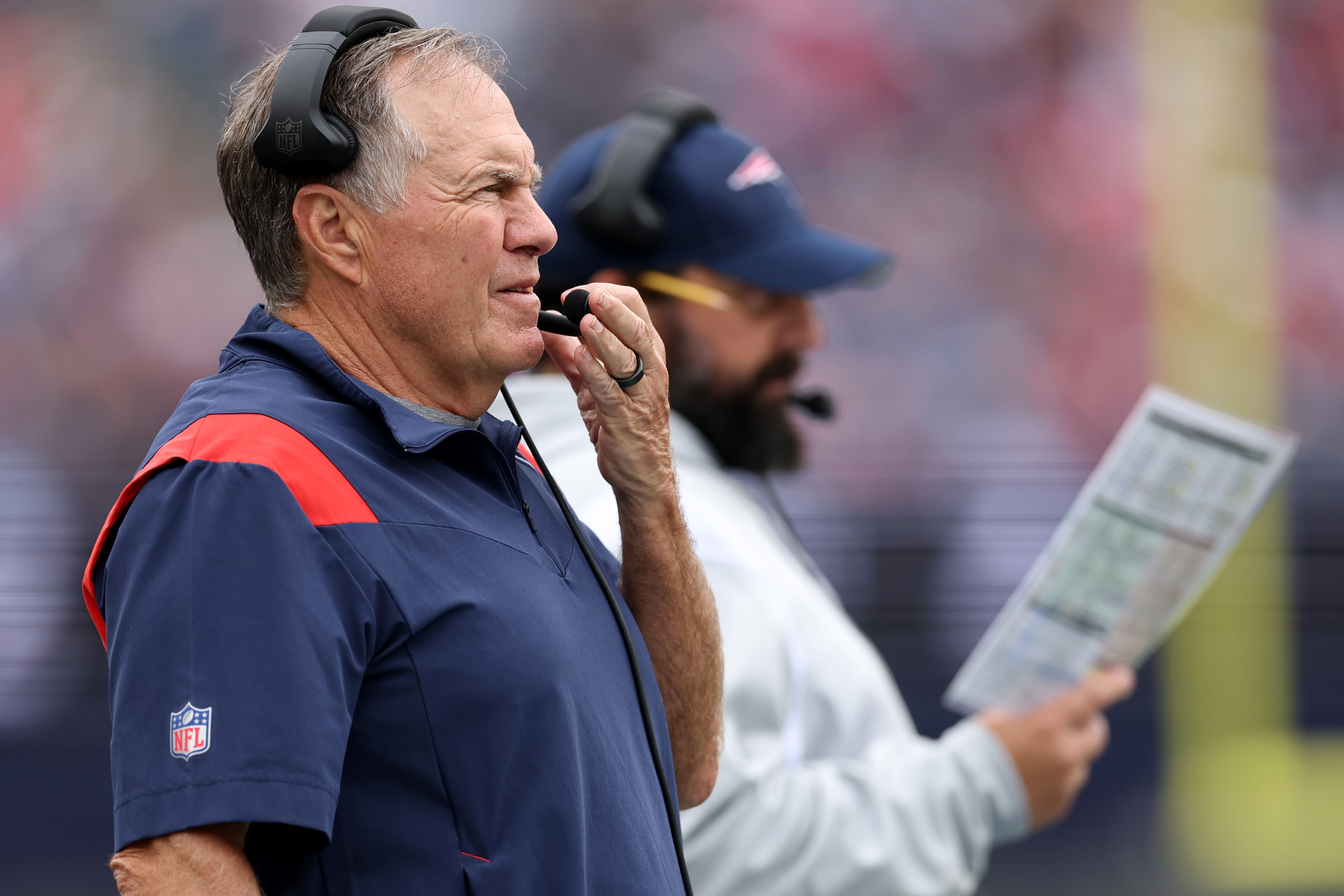 Head coach Bill Belichick of the New England Patriots stands on the sideline.