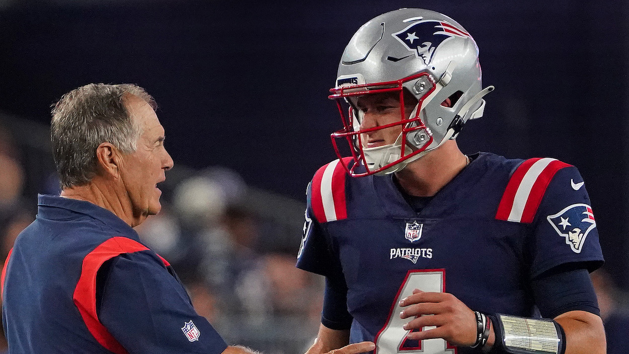 New England Patriots head coach Bill Belichick talks to quarterback Bailey Zappe.