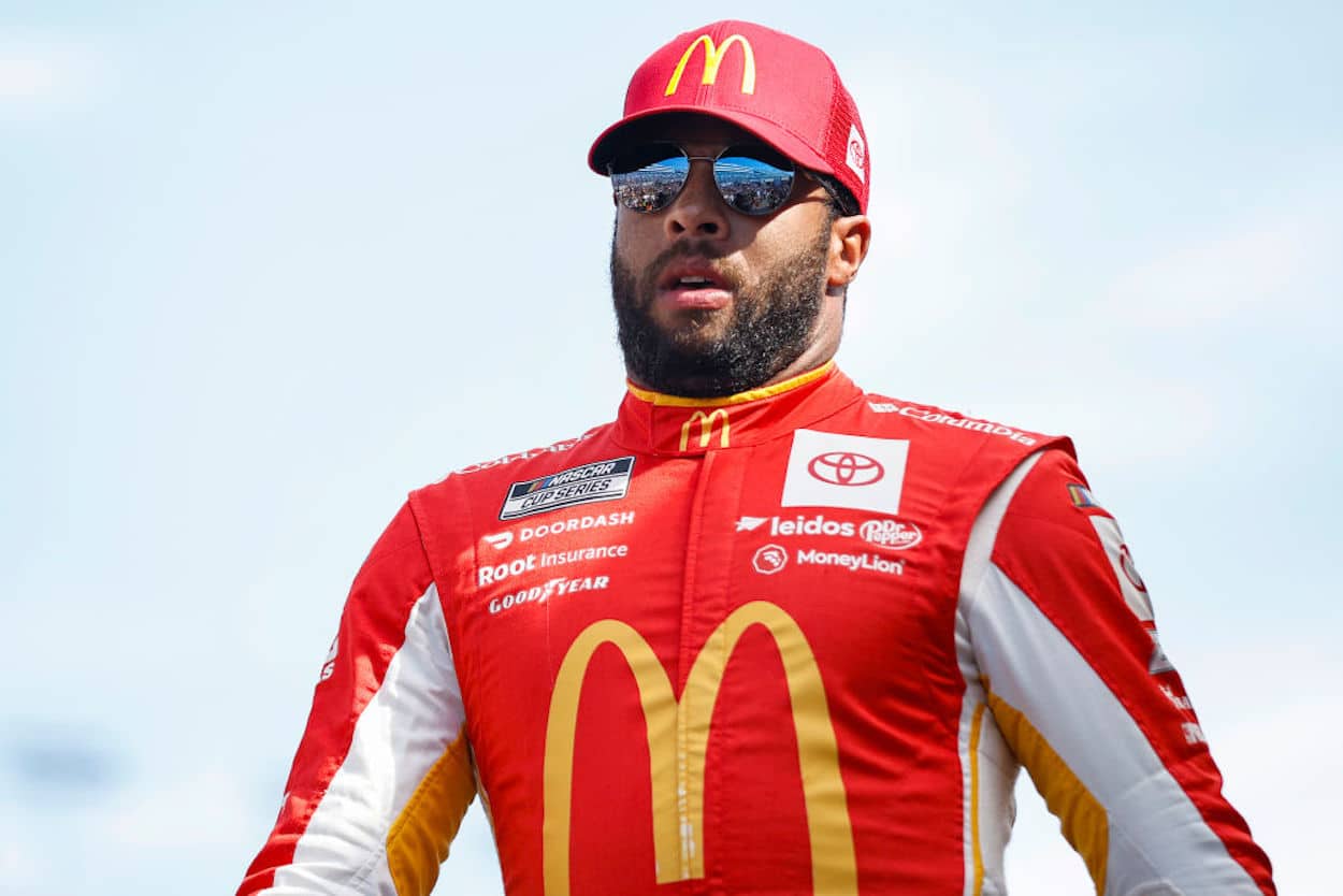 Bubba Wallace walks on stage ahead of a NASCAR Cup Series race.