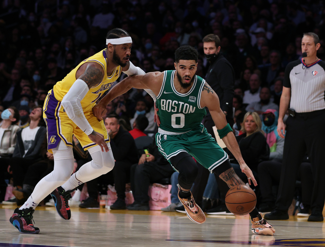 Jayson Tatum of the Boston Celtics drives to the basket past Carmelo Anthony of the Los Angeles Lakers.