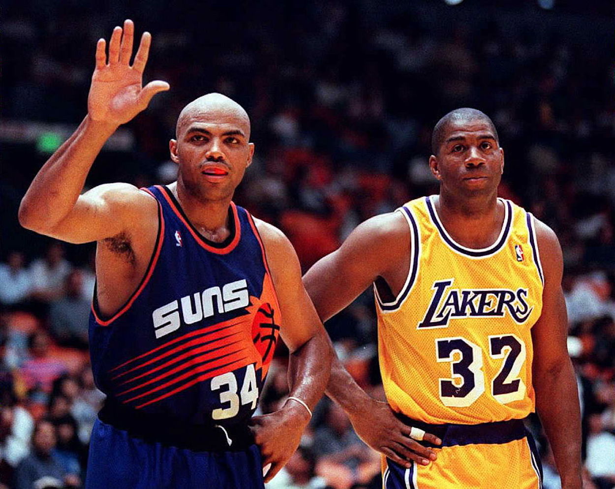 Charles Barkley (L) stands next to Magic Johnson during their NBA careers.