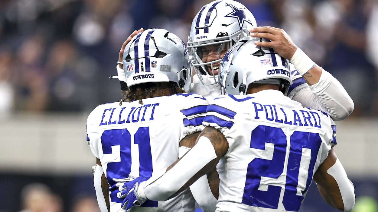 Dak Prescott of the Dallas Cowboys celebrates with Ezekiel Elliott and Tony Pollard.