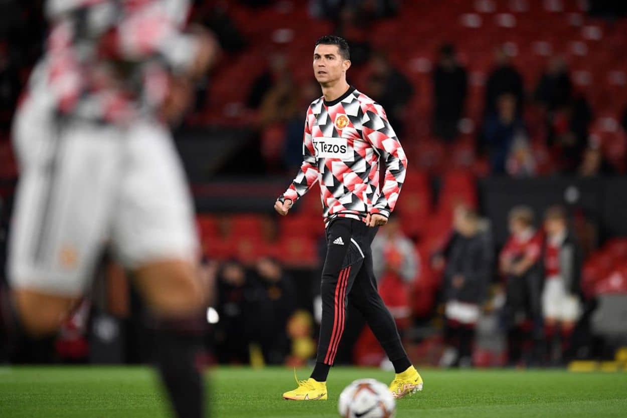 Manchester United forward Cristiano Ronaldo warms up on the Old Trafford pitch.