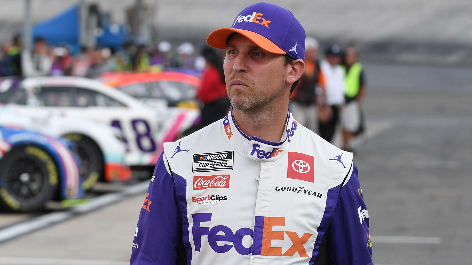 Denny Hamlin walks down pit road during qualifying for the NASCAR Cup Series Bass Pro Shops Night Race on Sept. 16, 2022, at Bristol Motor Speedway.