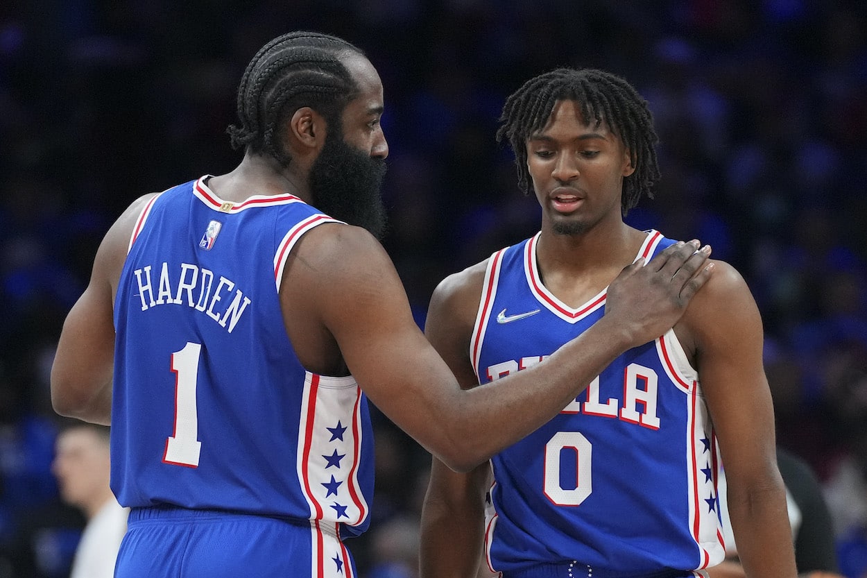 James Harden and Tyrese Maxey talk on the court.