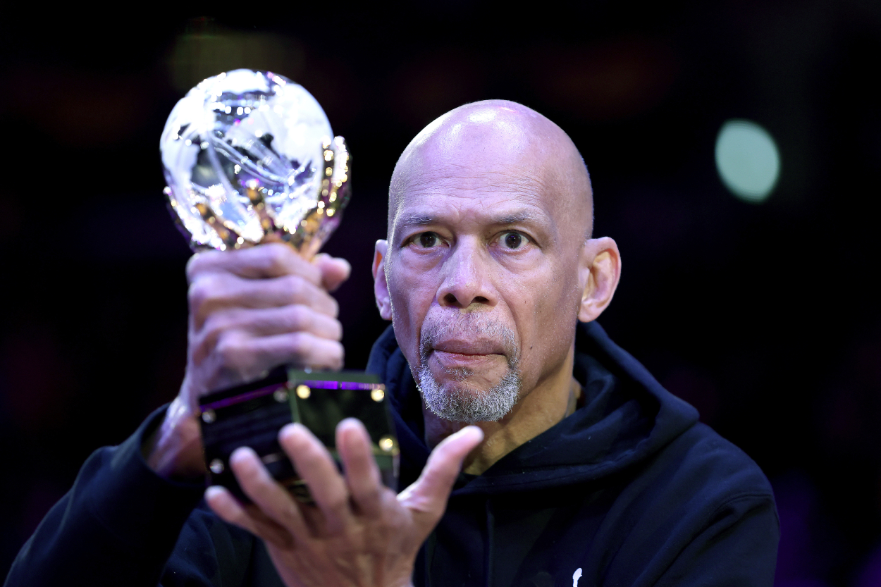Retired basketball player Kareem Abdul-Jabbar holds the trophy for the league's annual Social Justice Champion Award.