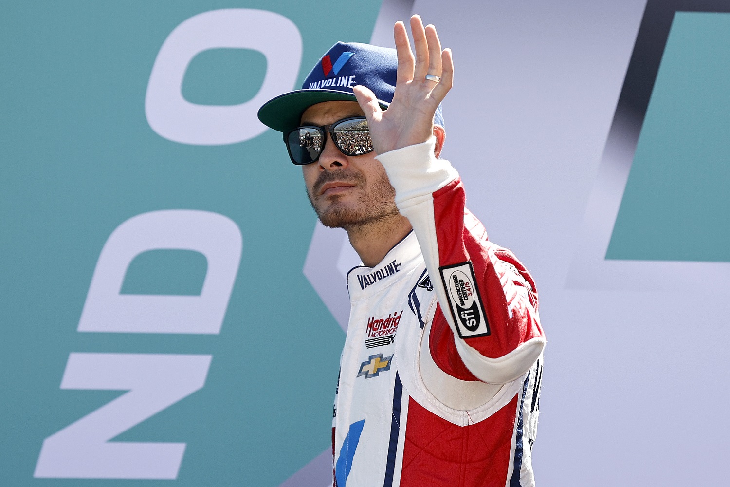 Kyle Larson waves to fans as he walks onstage during driver intros to the NASCAR Cup Series Dixie Vodka 400 at Homestead-Miami Speedway on Oct. 23, 2022 in Homestead, Florida.