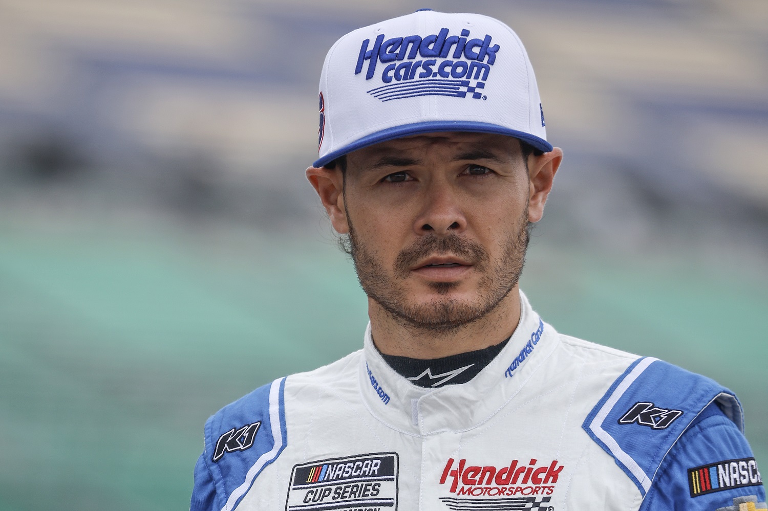 Kyle Larson walks the grid during practice for the NASCAR Cup Series Hollywood Casino 400 at Kansas Speedway on Sept. 10, 2022, in Kansas City, Kansas.