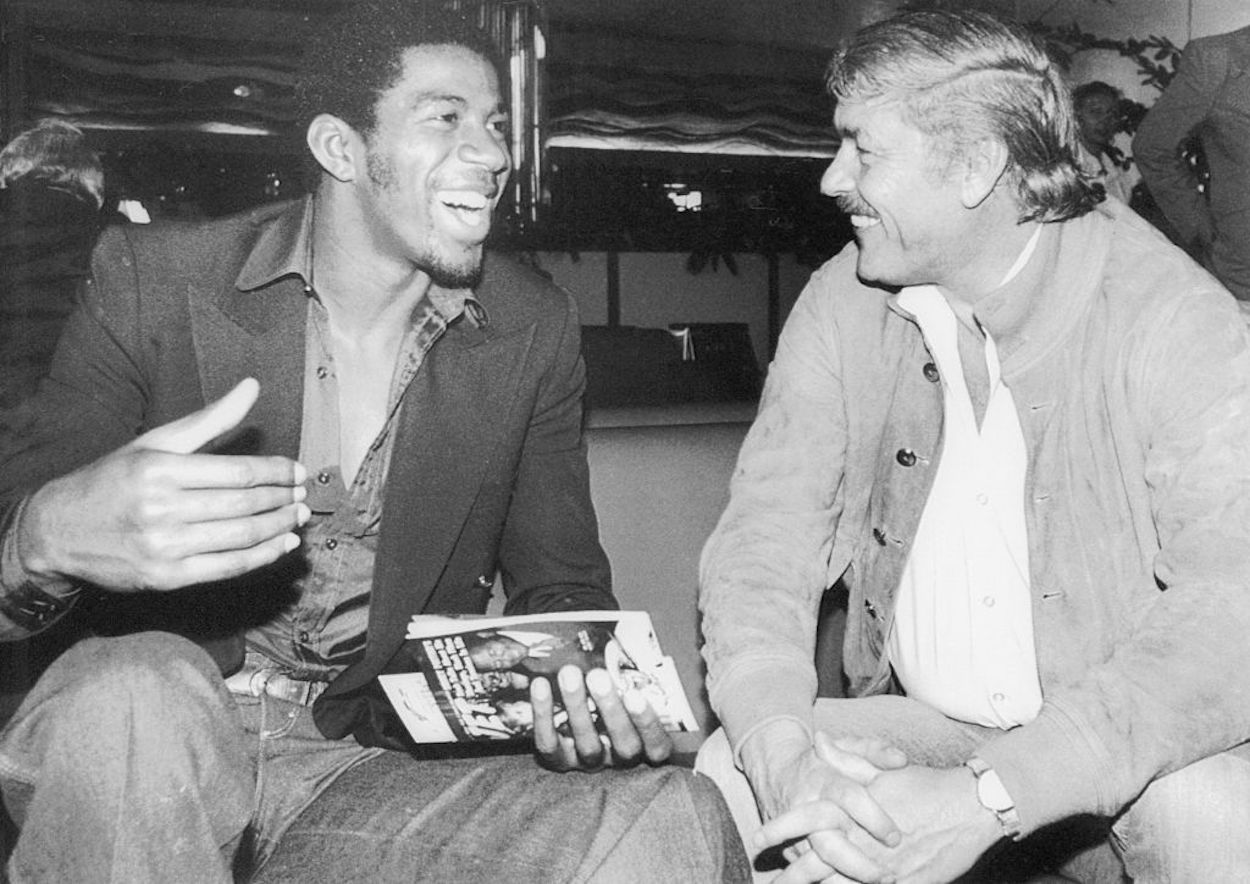 Magic Johnson (L) and Lakers owner Dr. Jerry Buss sit together in 1980.