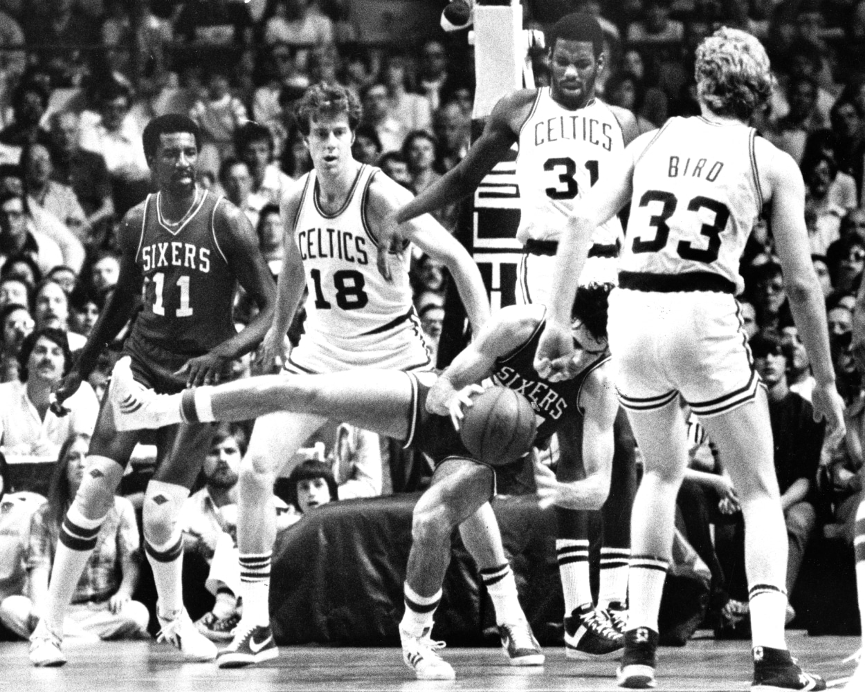 Boston Celtics forward Cedric Maxwell (31) fouls Philadelphia's Bobby Jones.