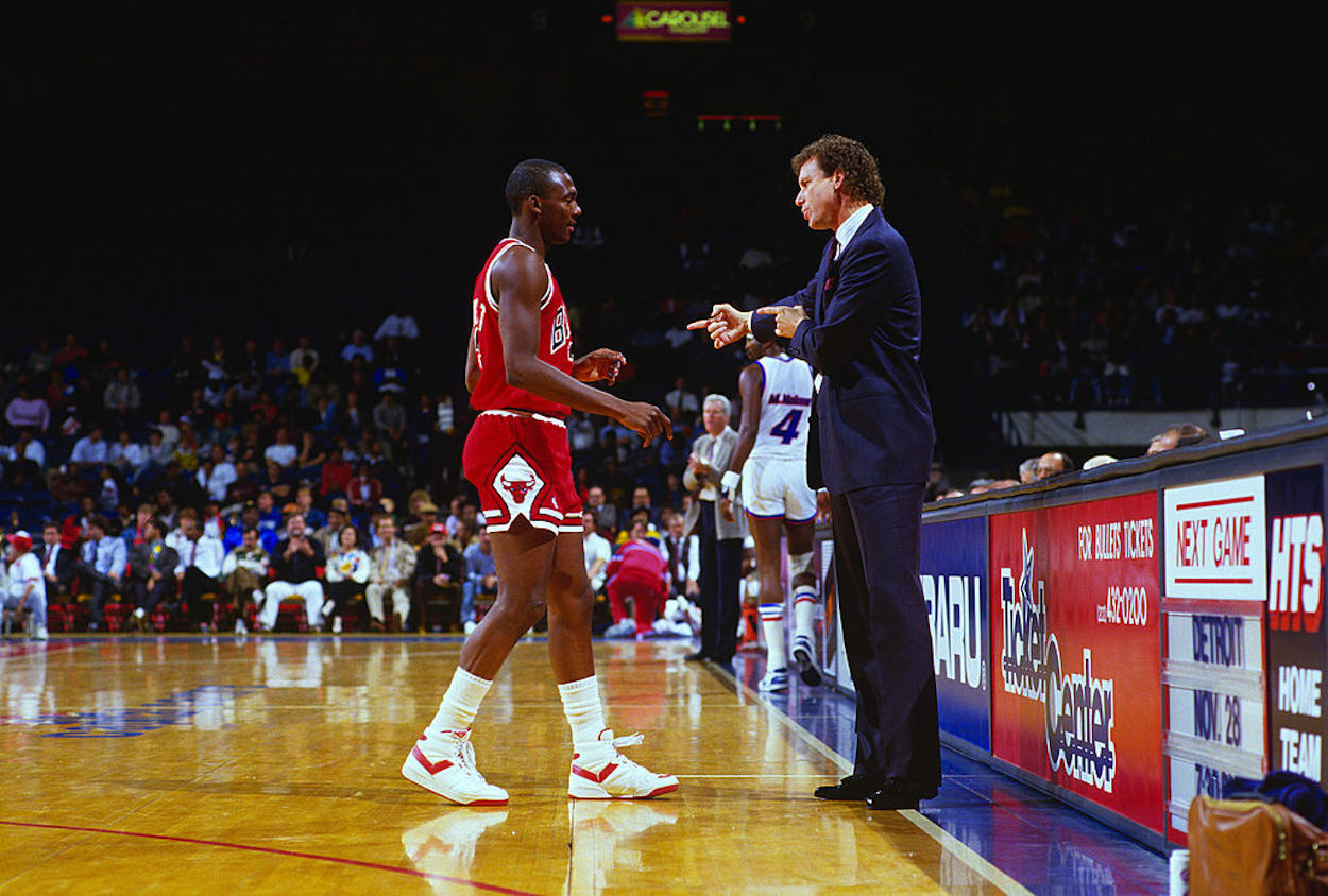 Michael Jordan (L) and Doug Collins (R) talk during a Chicago Bulls game.