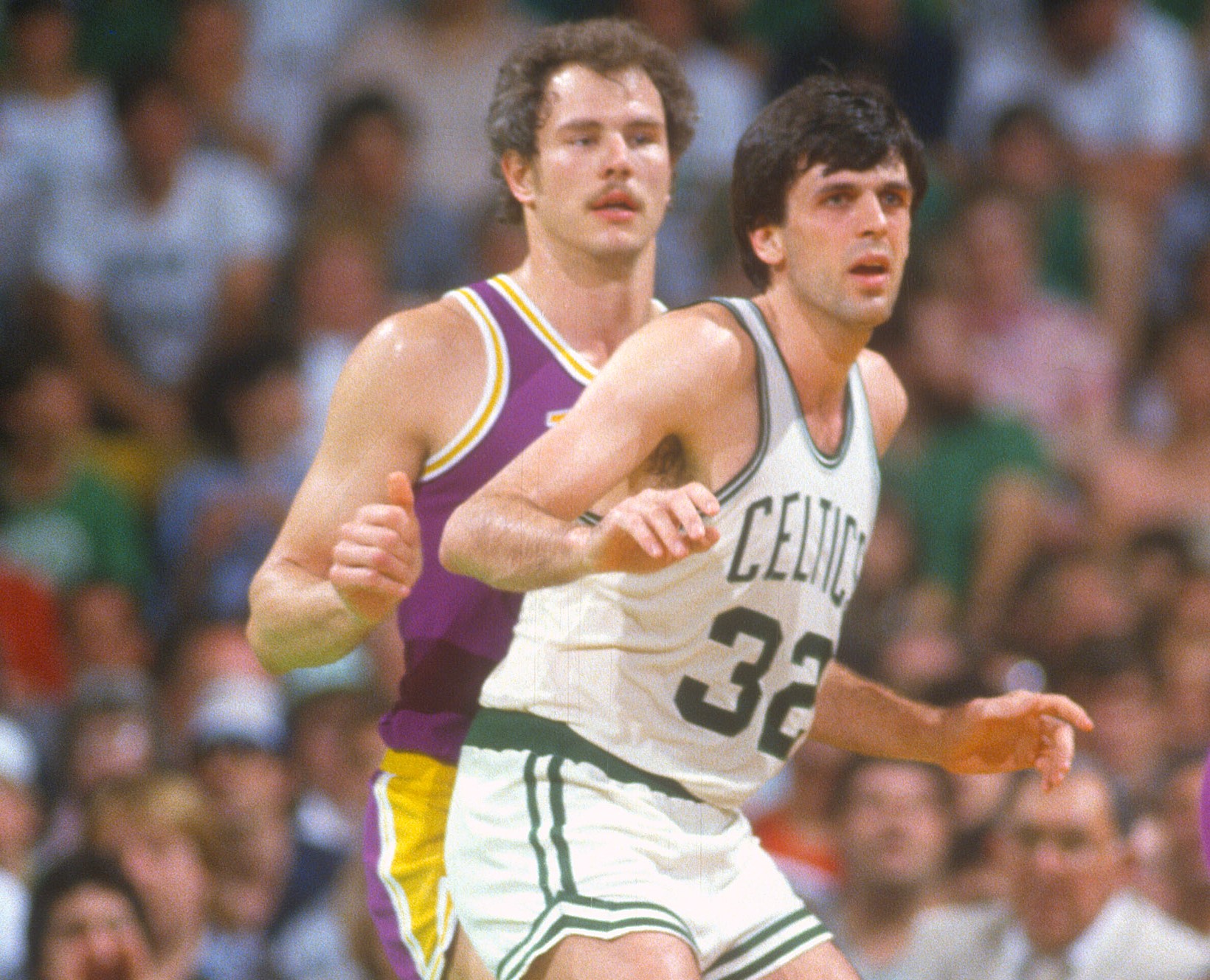 Kevin McHale of the Boston Celtics battles for position with Mitch Kupchak of the Los Angeles Lakers.