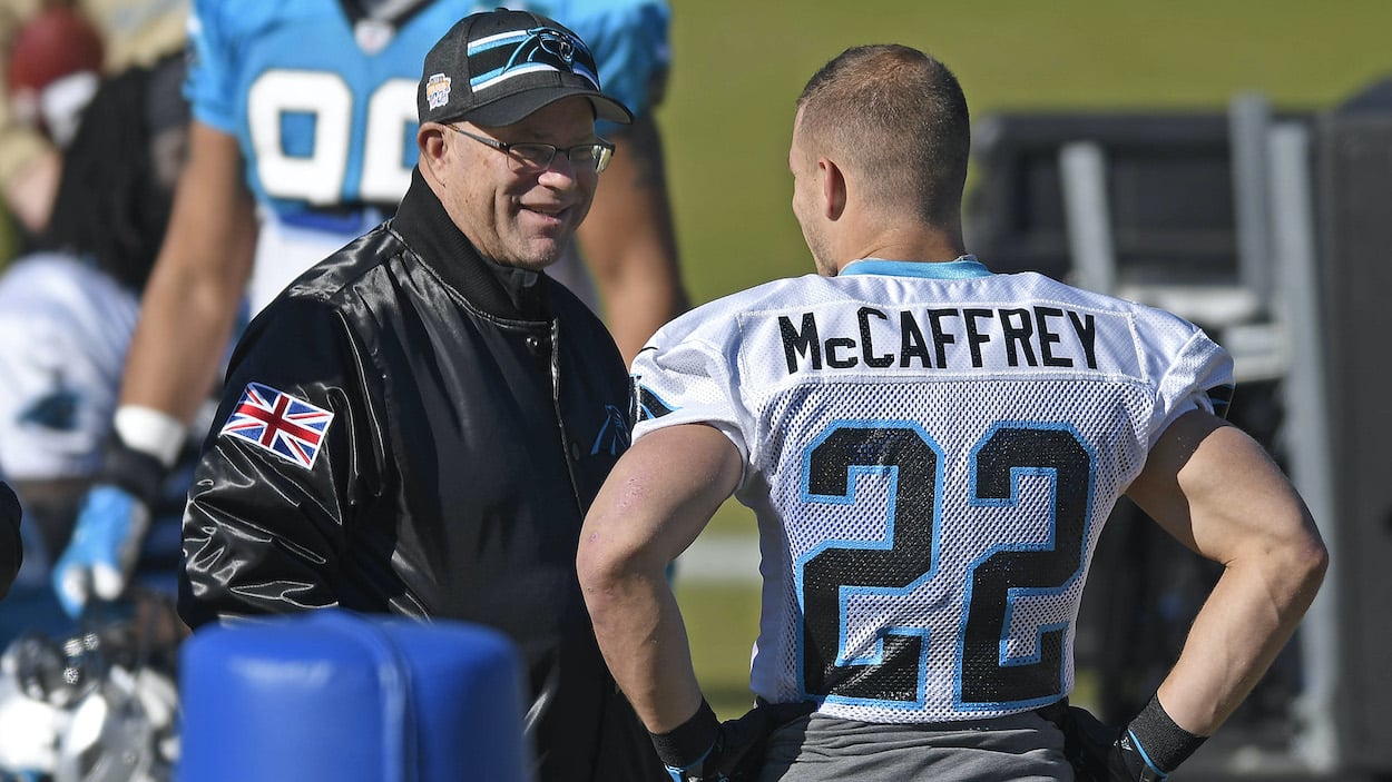 Carolina Panthers owner David Tepper talks with running back Christian McCaffrey.