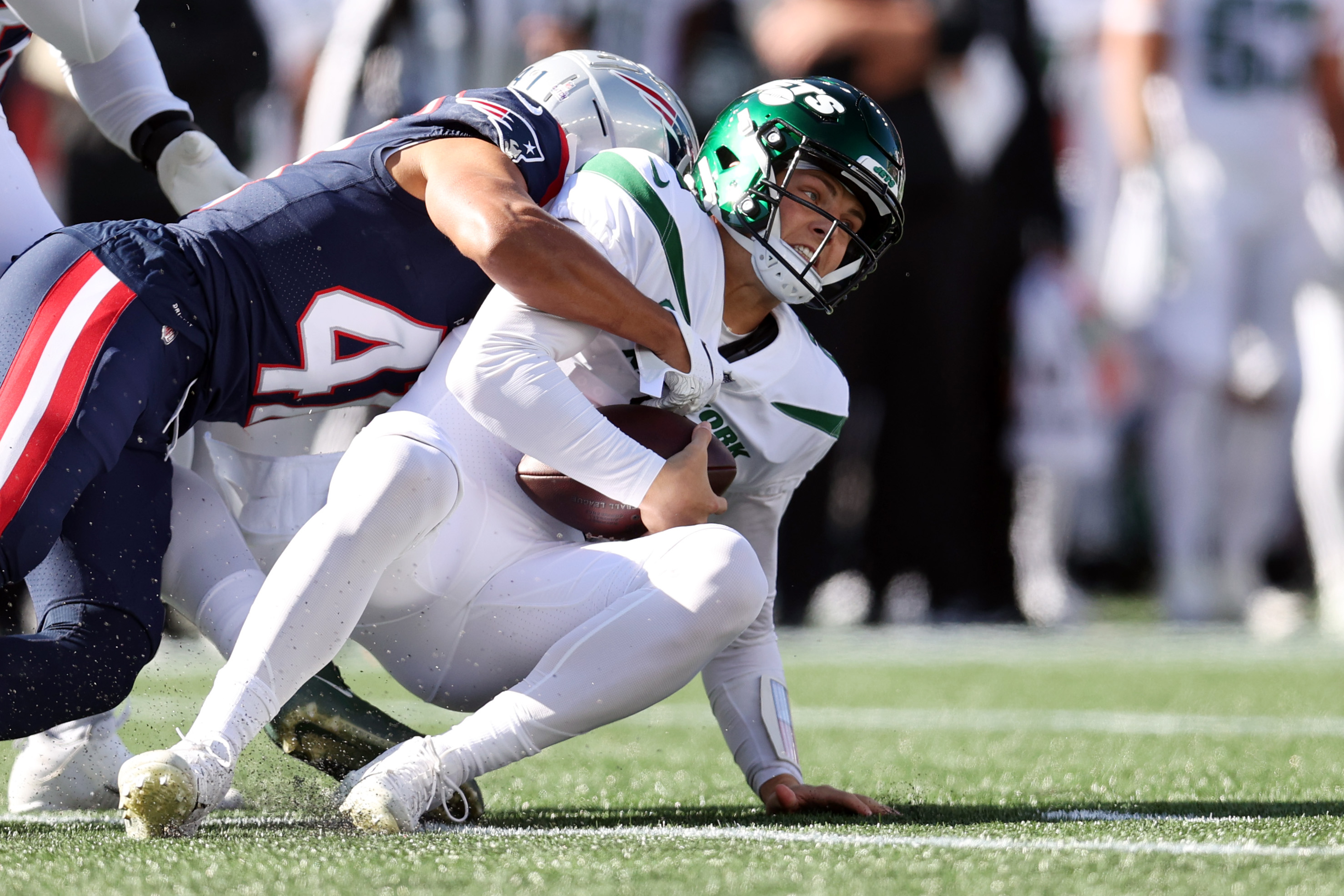 Myles Bryant of the New England Patriots sacks Zach Wilson of the New York Jets at Gillette Stadium on October 24, 2021, in Foxborough, Massachusetts.