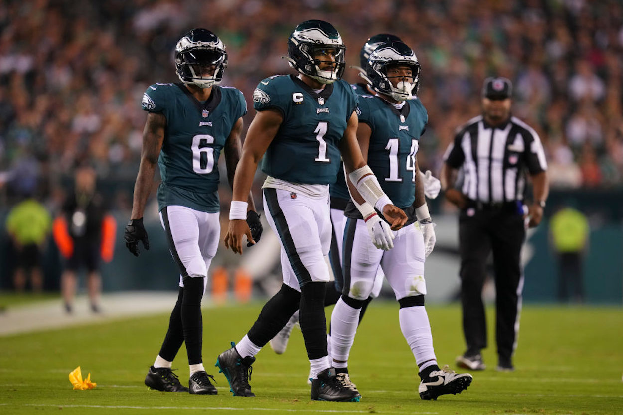 DeVonta Smith #6, Jalen Hurts #1, and Kenneth Gainwell #14 of the Philadelphia Eagles walk to the huddle.