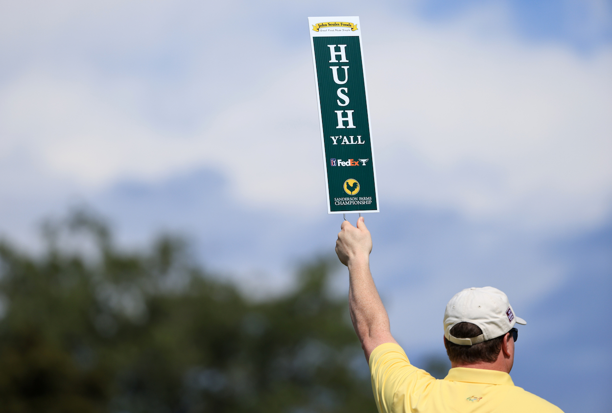 A volunteer holds up a sign at the Sanderson Farms Championship.