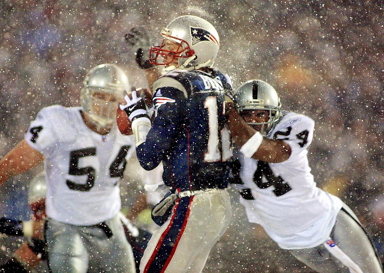 Tom Brady gets hit by Charles Woodson in the Tuck Rule Game in January 2002