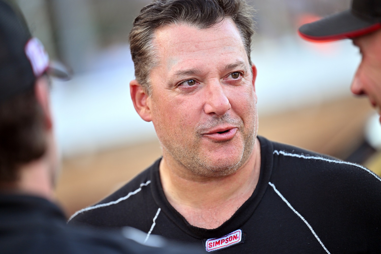 Tony Stewart talks to other drivers prior to the SRX qualifying race at Sharon Speedway on July 23, 2022 in Hartford, Ohio.