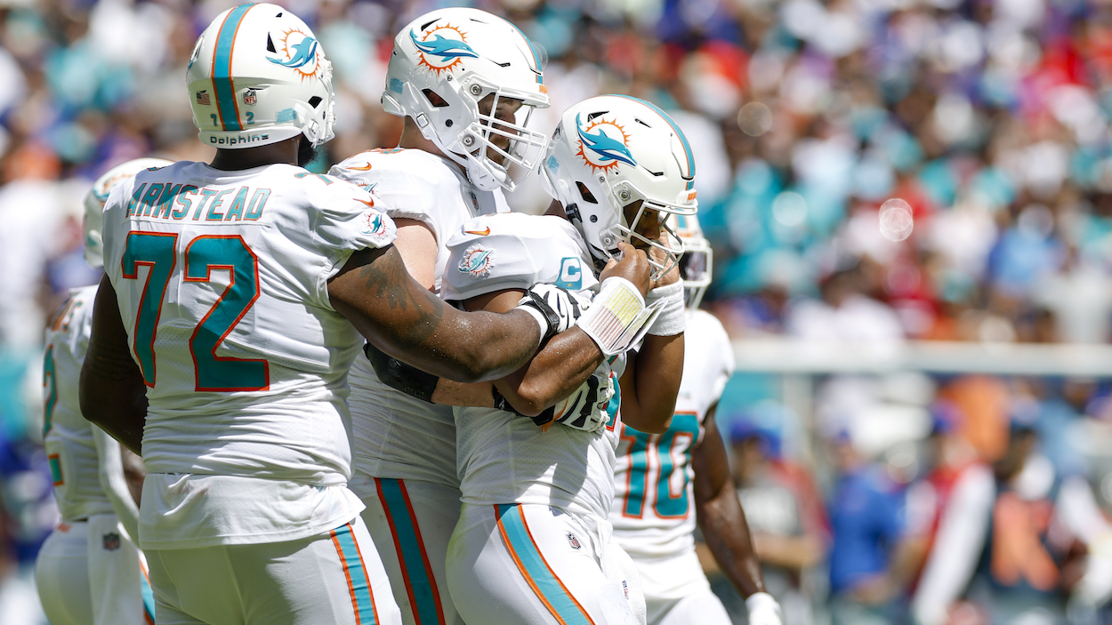 Miami Dolphins offensive tackle Liam Eichenberg (No. 74) and Miami Dolphins offensive tackle Terron Armstead (No. 72) holds up an injured Miami Dolphins quarterback Tua Tagovailoa (No. 1).