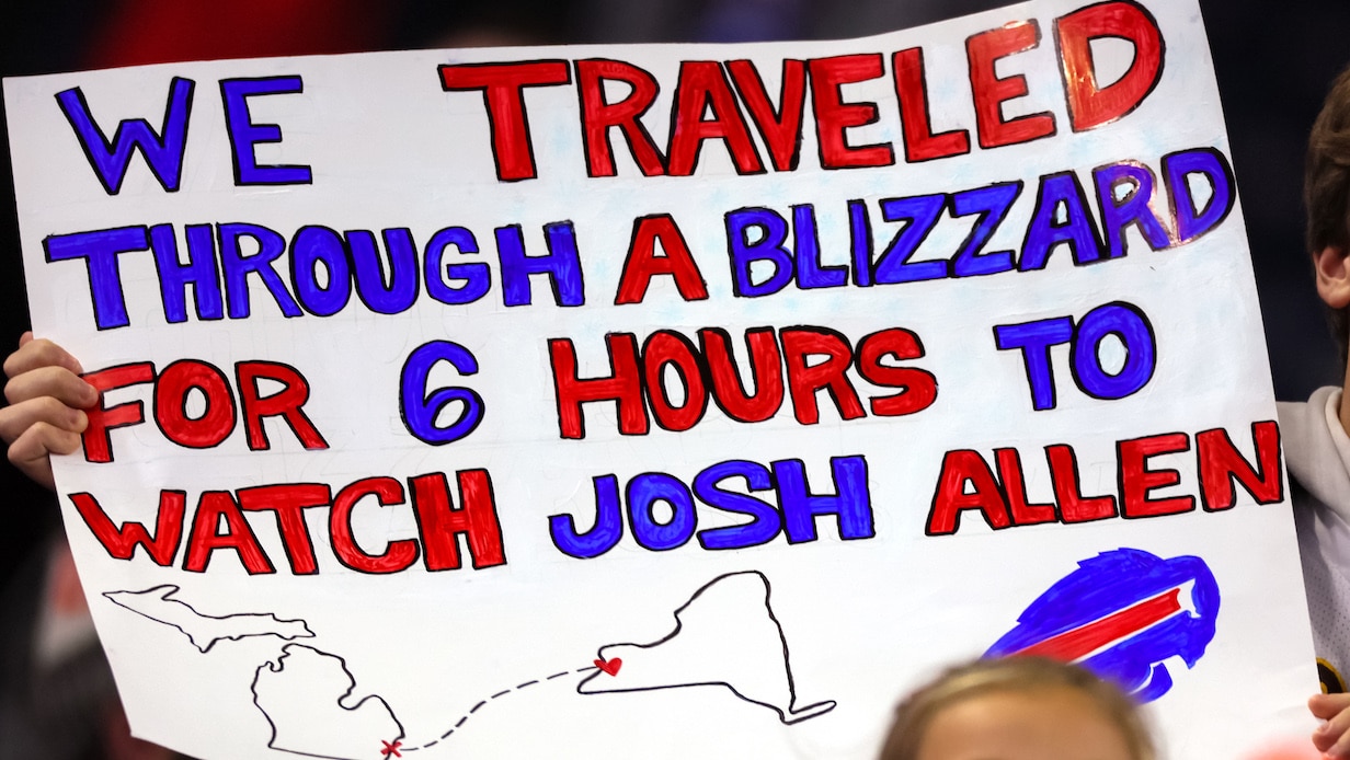 A fan holds a sign during an NFL football game between the Buffalo Bills and the Cleveland Browns in Detroit, Michigan.