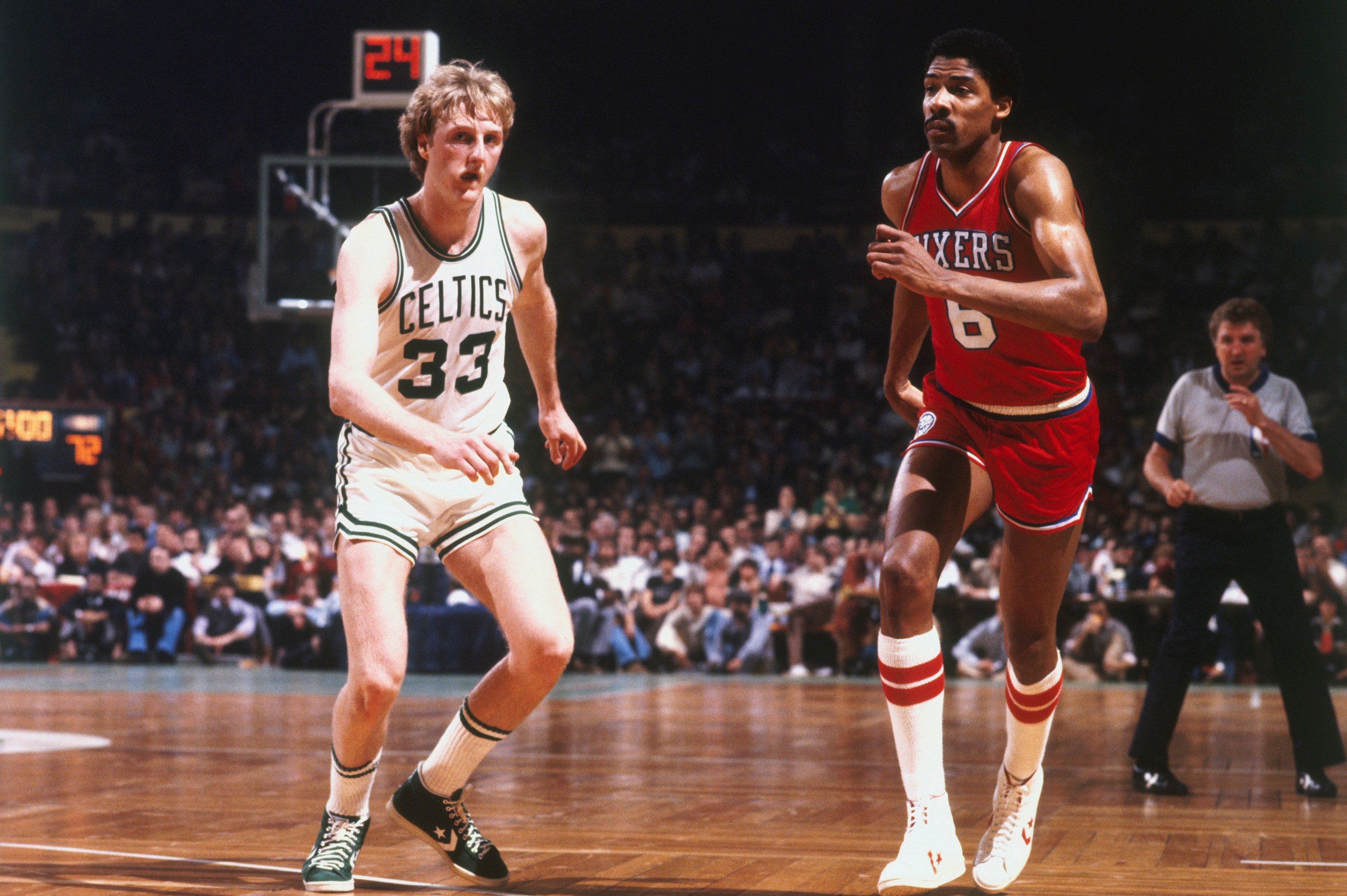 Larry Bird of the Boston Celtics runs to defend against Julius Erving.