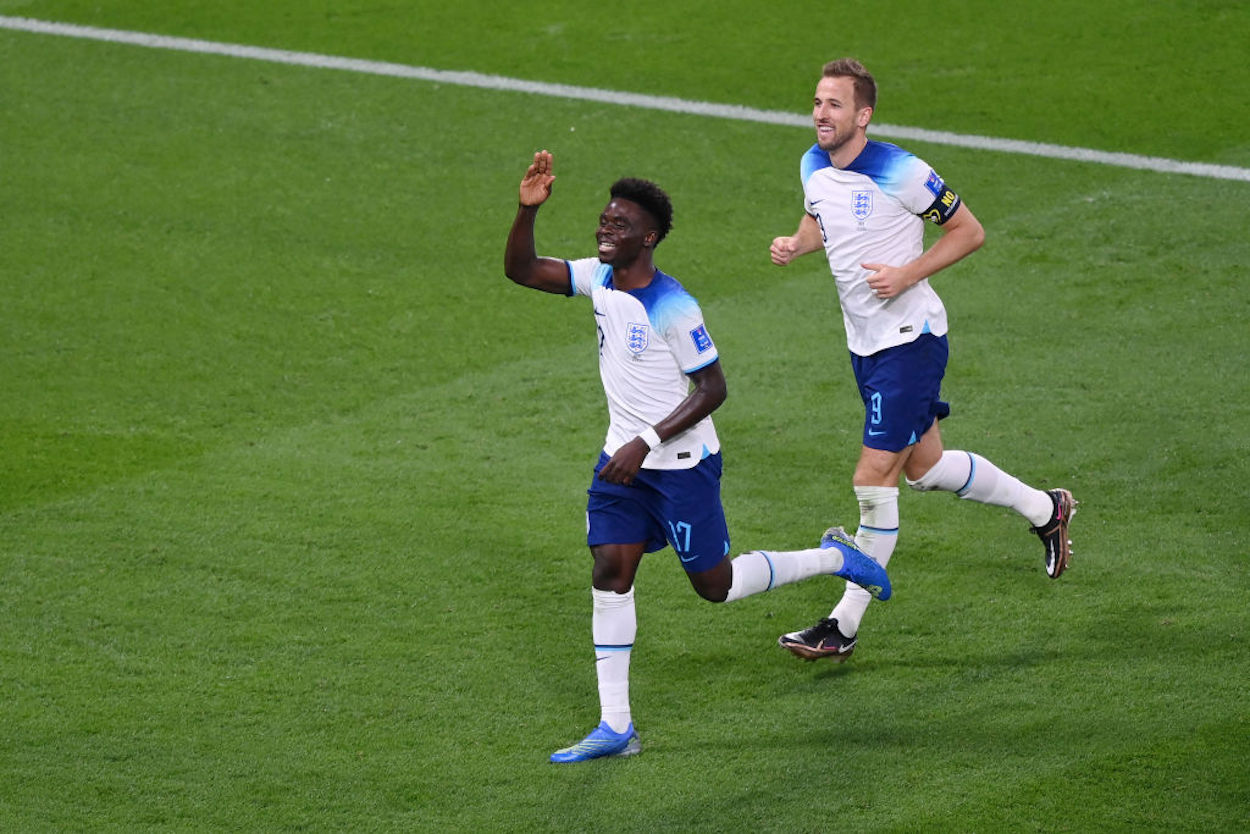 Bukayo Saka (L) celebrates scoring a goal during the 2022 FIFA World Cup.
