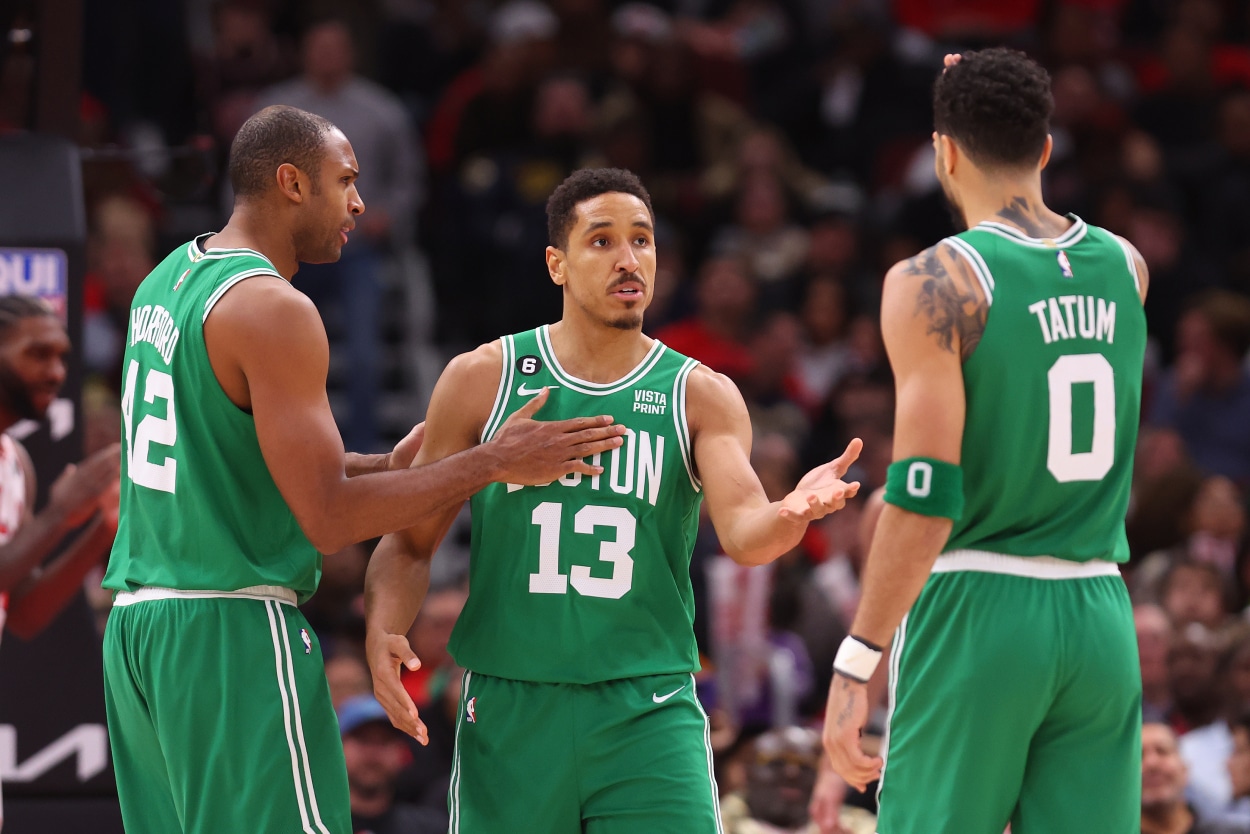 Malcolm Brogdon of the Boston Celtics celebrates with Al Horford and Jayson Tatum against the Chicago Bulls.