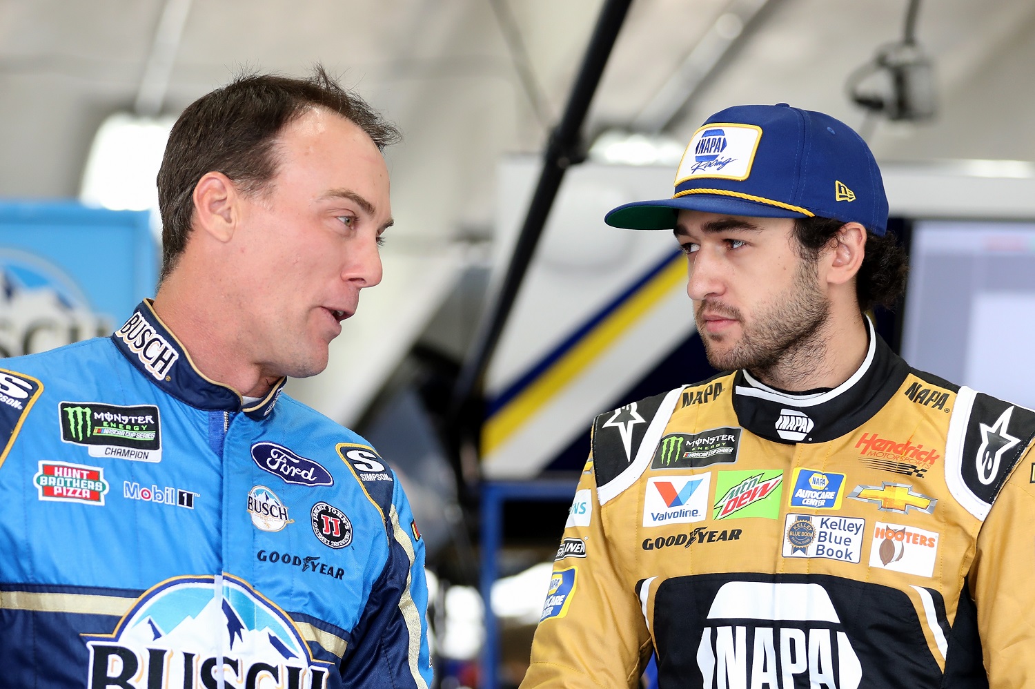 Kevin Harvick and Chase Elliott talk in the garage during practice for the NASCAR All-Star Race at Charlotte Motor Speedway on May 17, 2019.