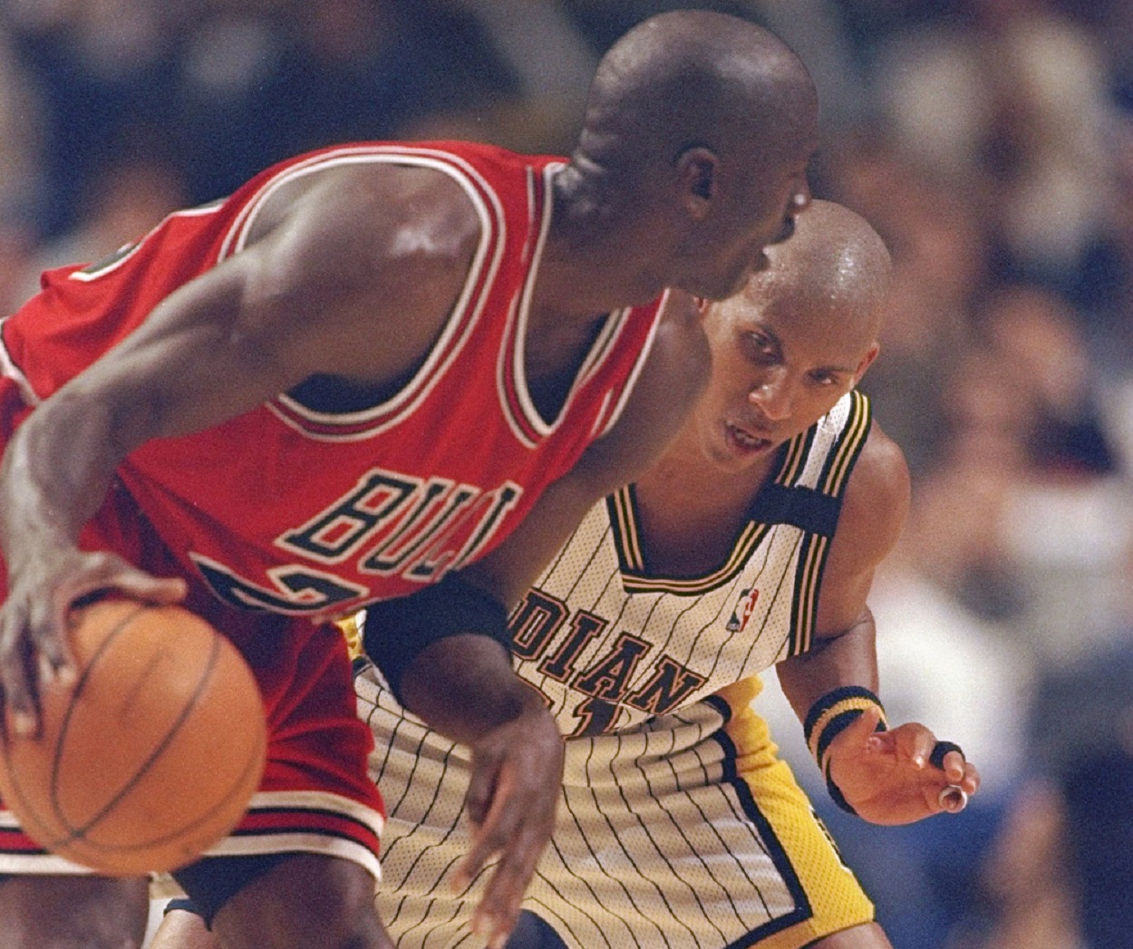 Michael Jordan and Reggie Miller battle during a Bulls-Pacers matchup