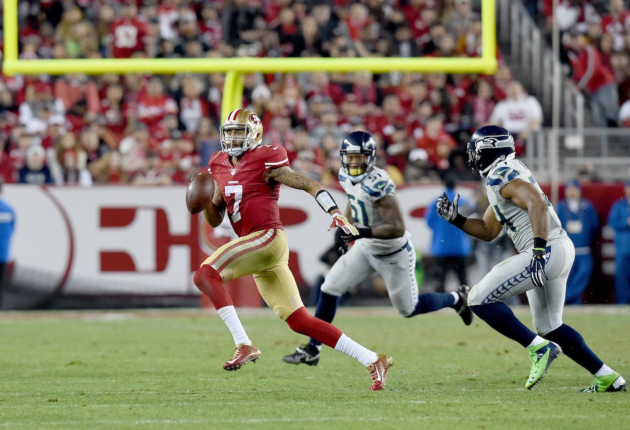 Colin Kaepernick tries to avoid the pursuit of Bruce Irvin and Bobby Wagner during the San Francisco 49ers' Thanksgiving loss to the Seattle Seahawks in 2014.