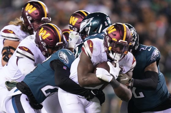 Brian Robinson Jr. runs through the Eagles defense.
