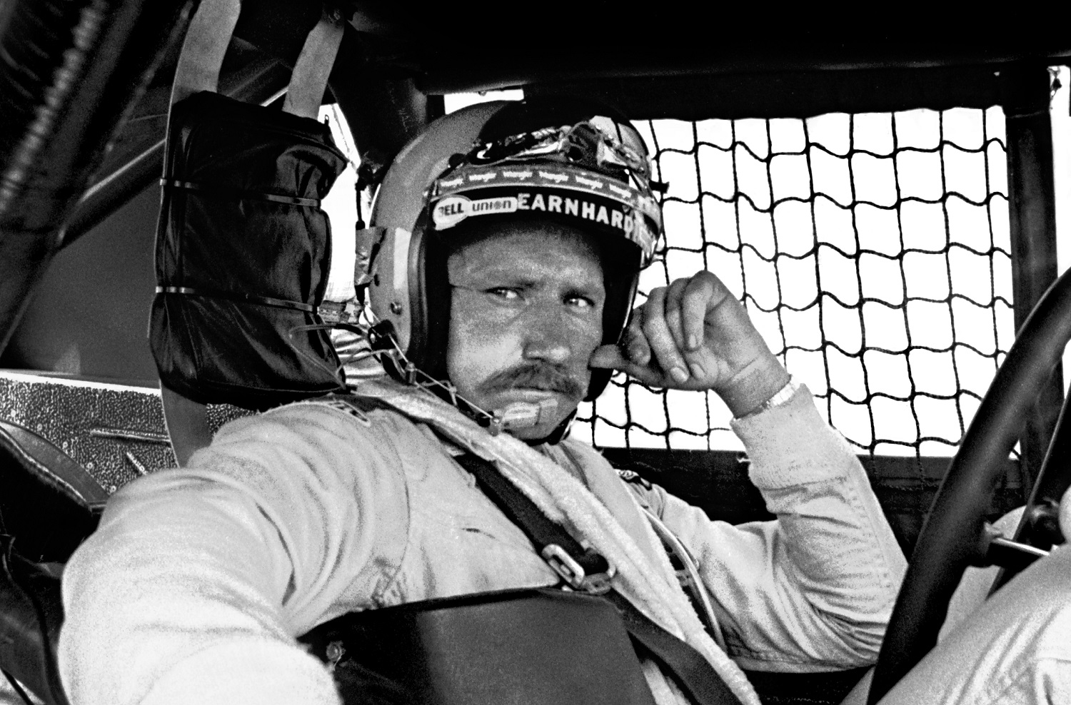 NASCAR driver Dale Earnhardt Sr. sits in his car prior to the 1981 Firecracker 400 NASCAR race at Daytona International Speedway.