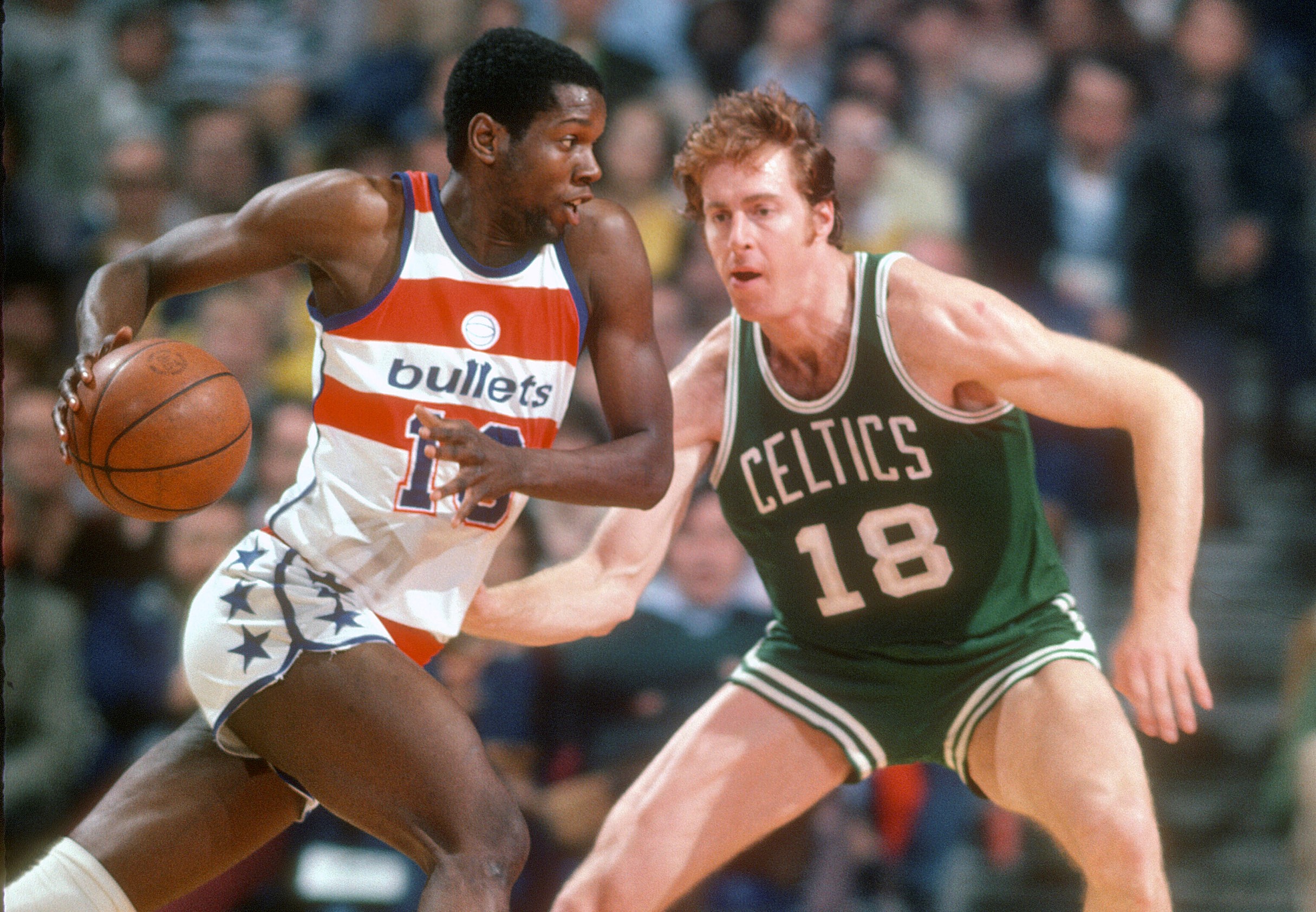 Bob Dandridge of the Washington Bullets drives on Dave Cowens of the Boston Celtics.