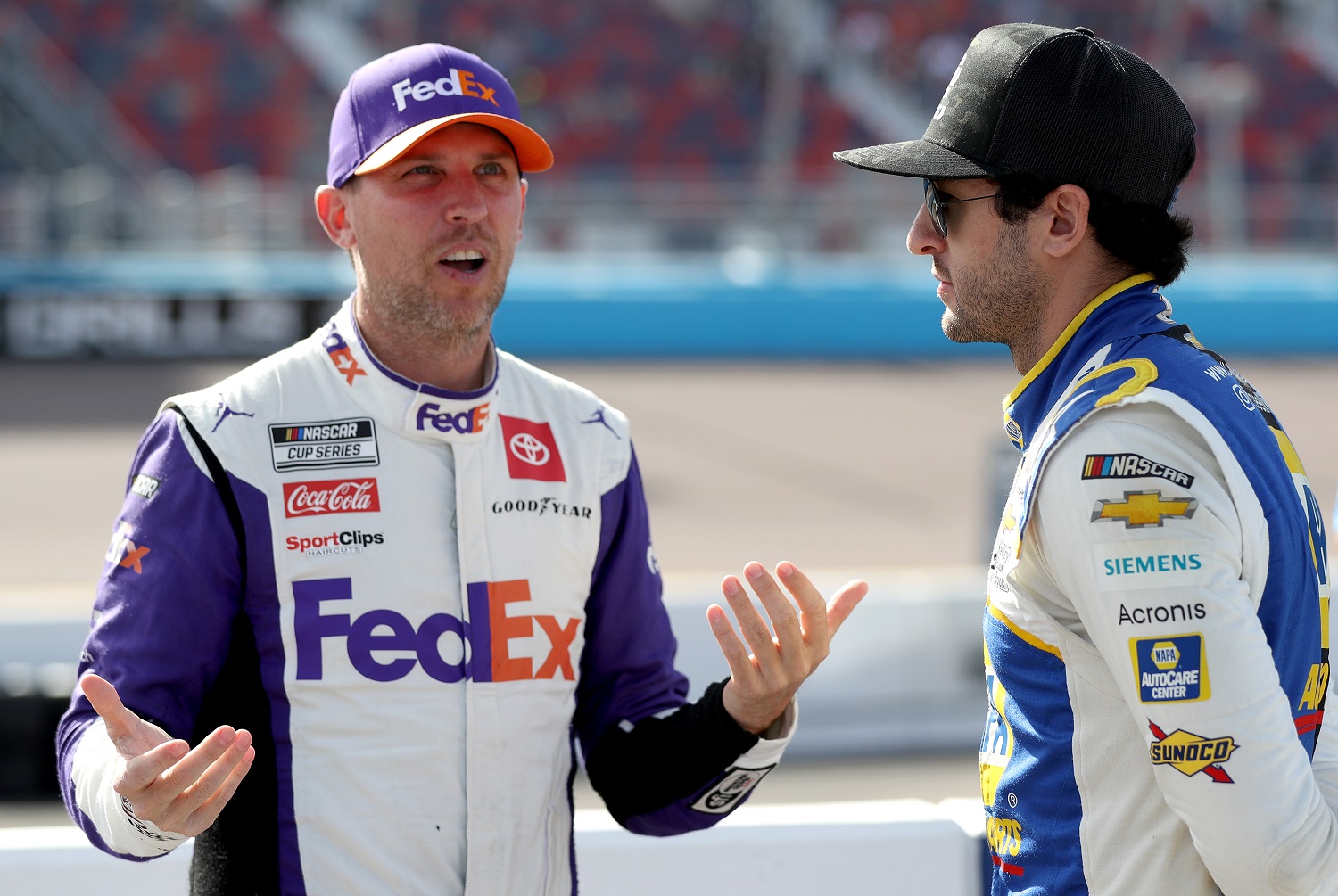 Denny Hamlin and Chase Elliott talk on the grid during qualifying for the NASCAR Cup Series Championship at Phoenix Raceway on Nov. 5, 2022. | Meg Oliphant/Getty Images