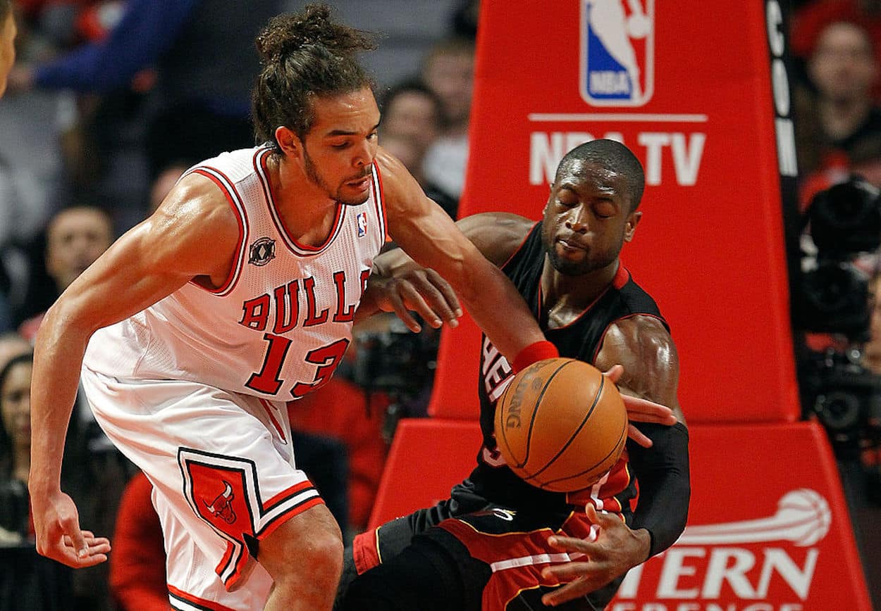 Joakim Noah (L) and Dwyane Wade (R) battle for a loose ball.