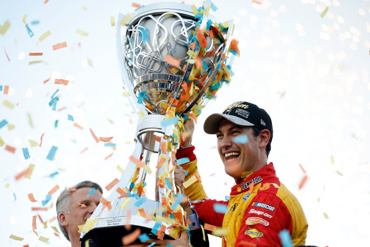 Joey Logano receives his trophy as NASCAR Cup Series champion.