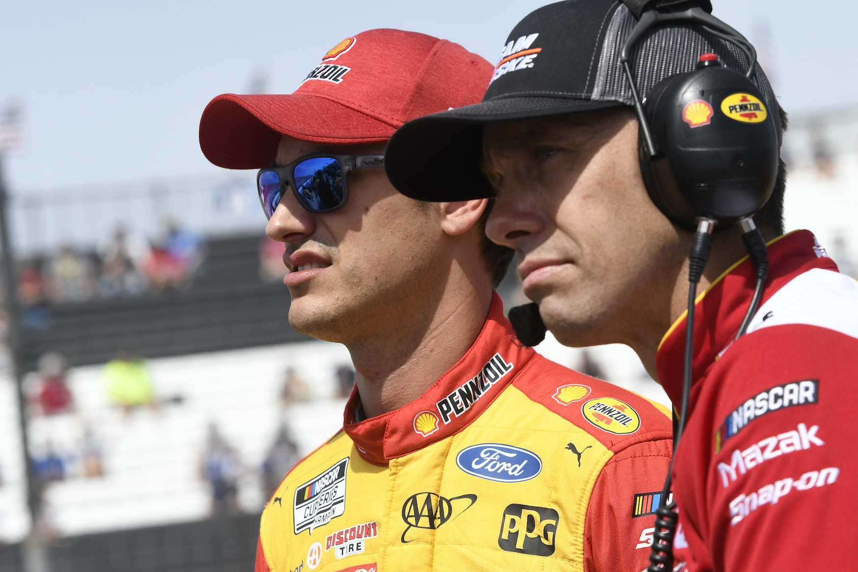Joey Logano and crew chief Paul Wolfe watch qualifying