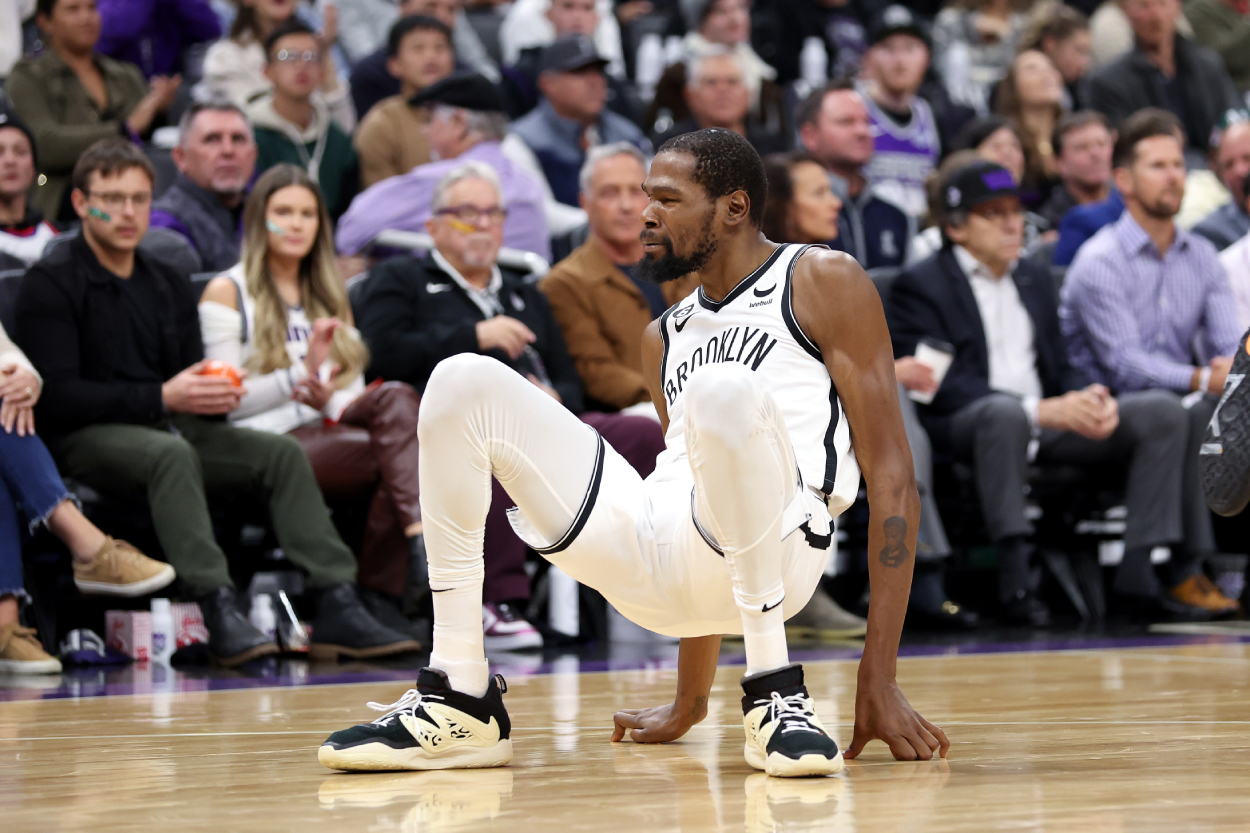 Kevin Durant of the Brooklyn Nets gets back up after falling on the court.