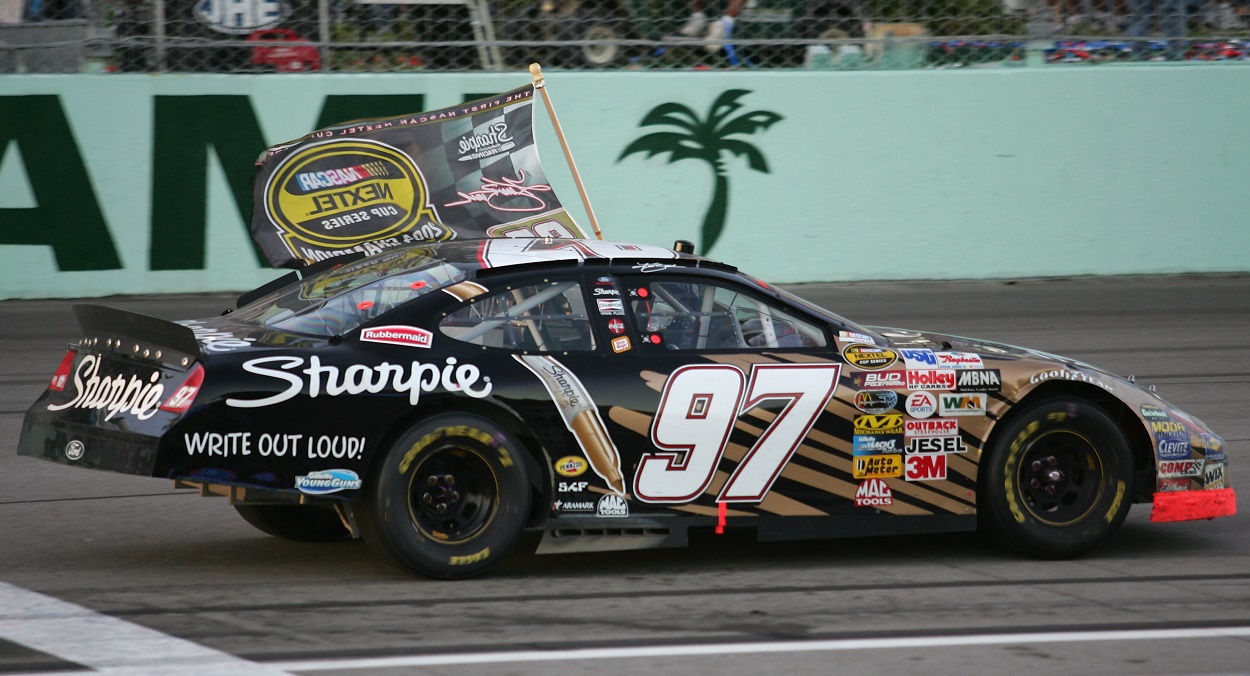 Kurt Busch celebrates winning the NASCAR Cup Series title in 2004