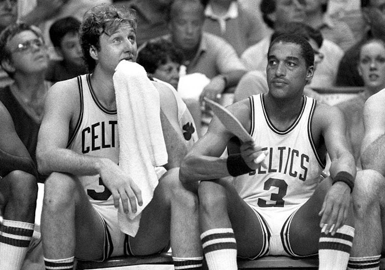 Larry Bird (L) and Dennis Johnson (R) sit on the Boston Celtics bench.