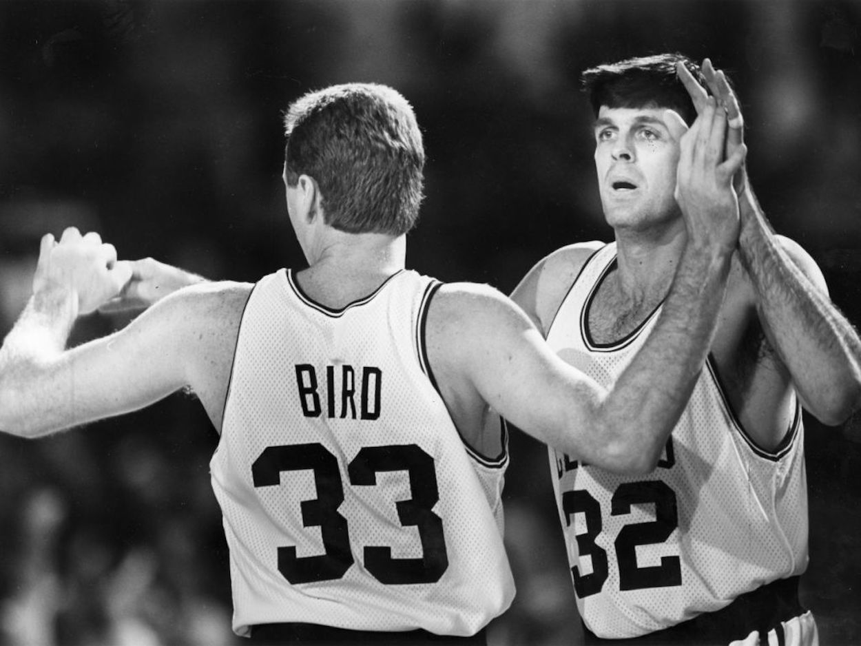 Larry Bird (L) and Kevin McHale (R) high-five as Celtics teammates.