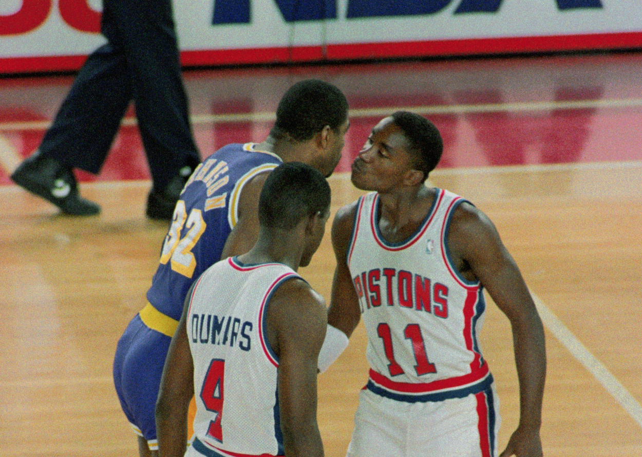 Detroit Pistons guard Isiah Thomas (right) and Los Angeles Lakers star Magic Johnson kiss before the jump ball to start their NBA Finals game.