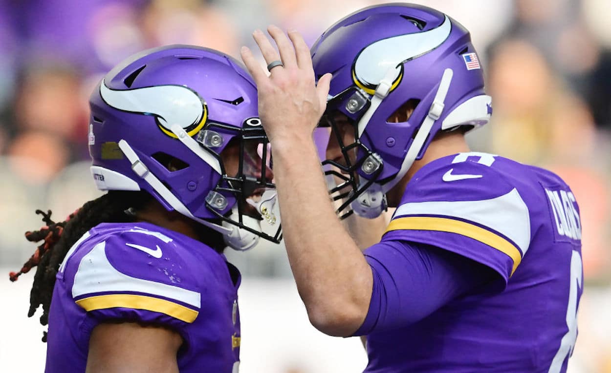 Alexander Mattison (L) and Kirk Cousins (R) celebrate a touchdown together.