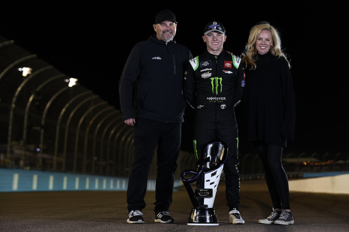 Ty Gibbs, driver of the #54 Monster Energy Toyota, poses with his father Coy Gibbs and mother Heather Gibbs after winning the NASCAR Xfinity Series Championship at Phoenix Raceway on November 5, 2022