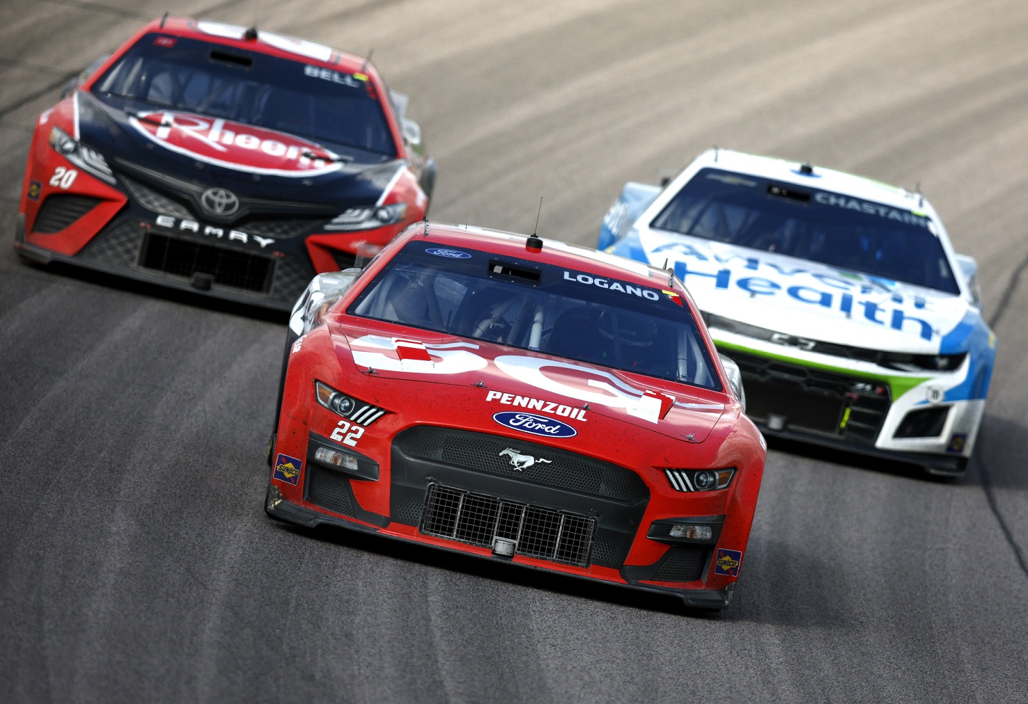 Joey Logano Christopher Bell, and Ross Chastain race during the NASCAR Cup Series AdventHealth 400 at Kansas Speedway on May 15, 2022.