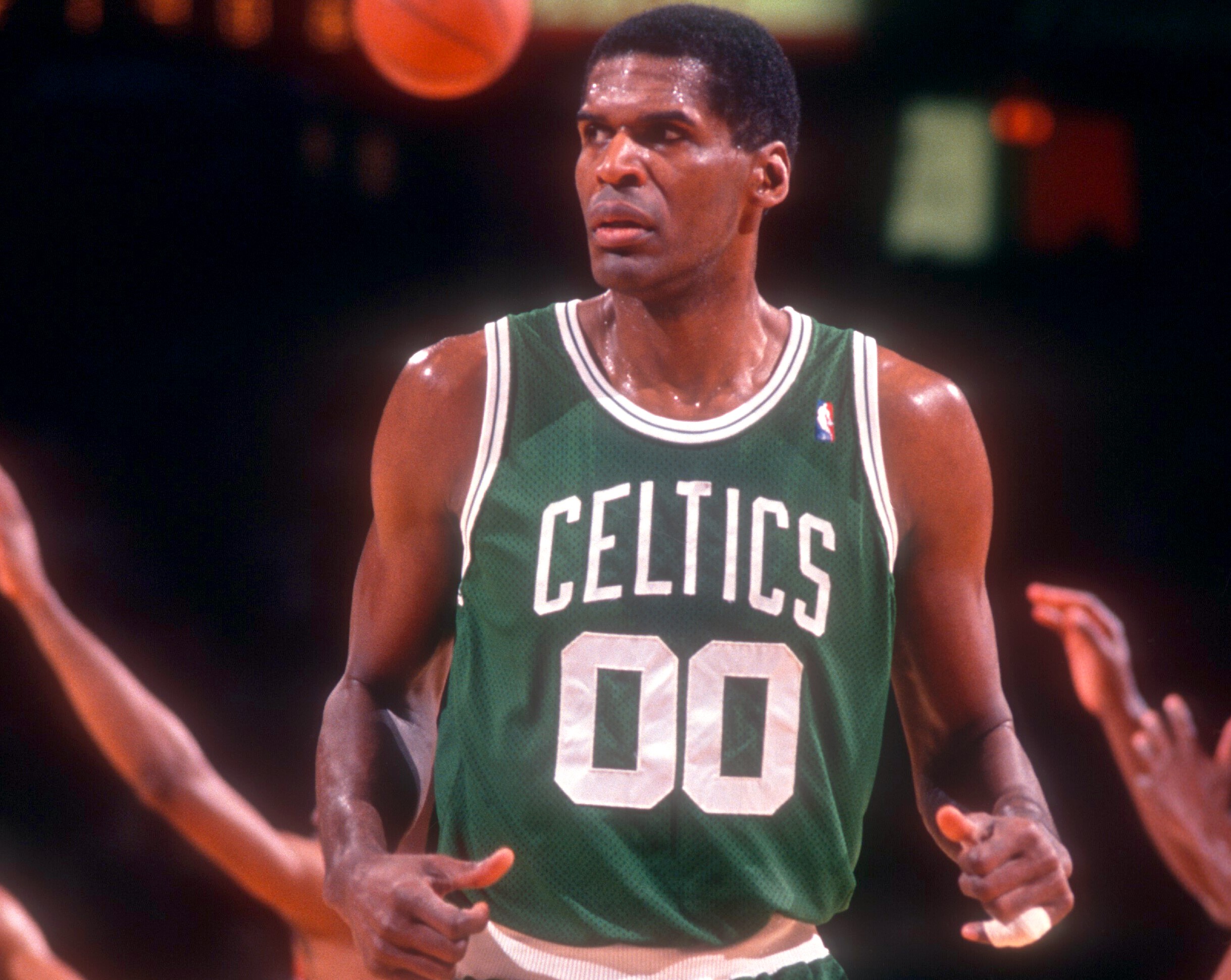 Robert Parish of the Boston Celtics stands on the court during an NBA game against the Philadelphia 76ers.