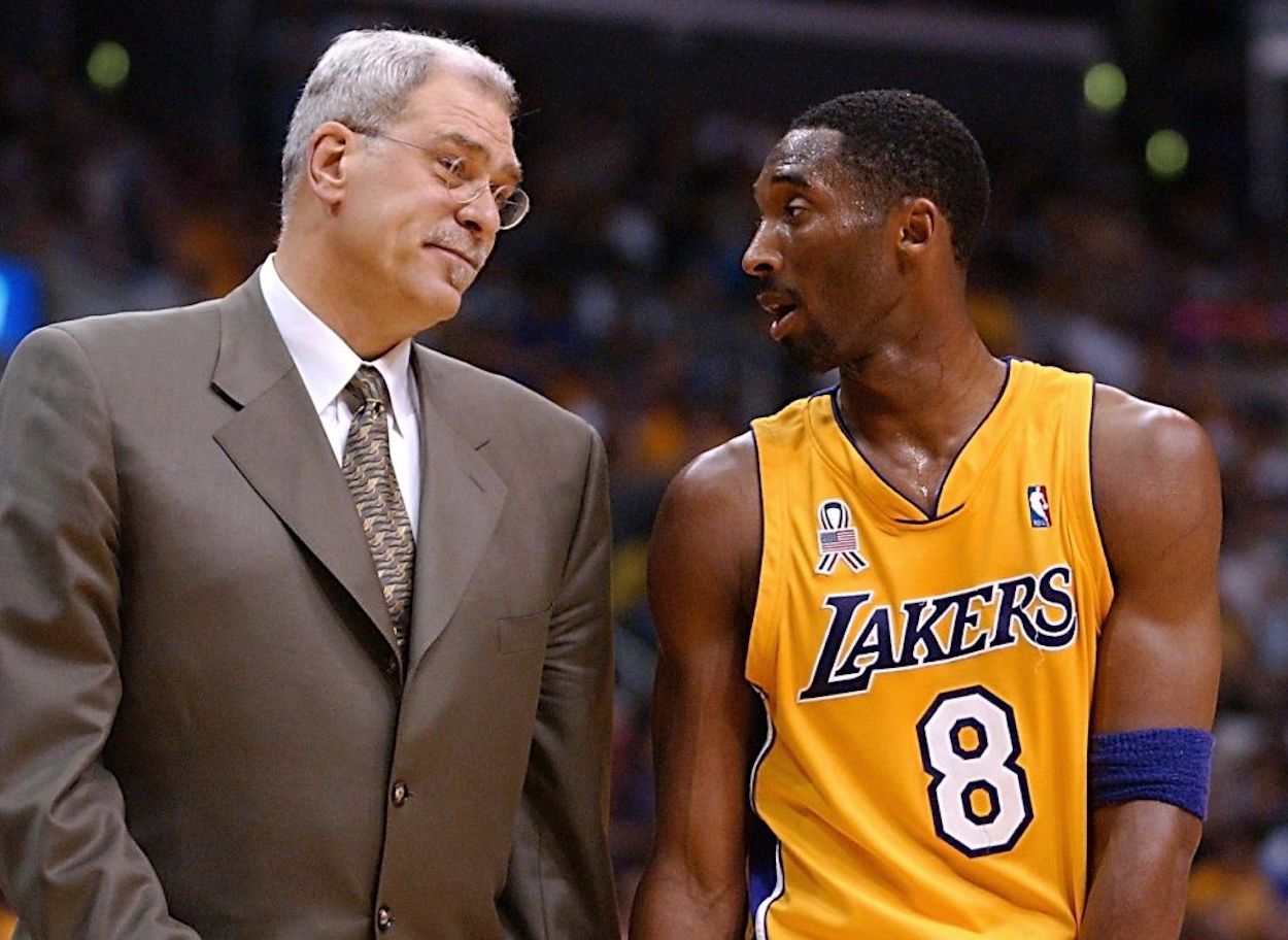 Phil Jackson (L) and Kobe Bryant (R) share a look on the court.